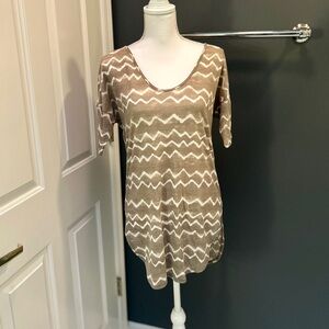 Lightweight tunic-length soft tee with extended short sleeves.